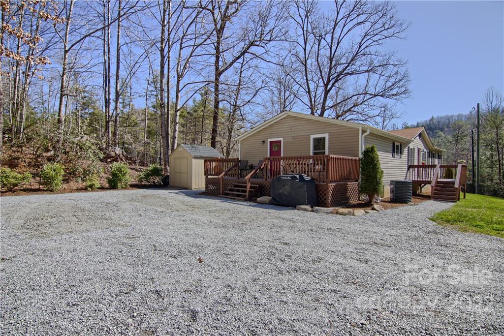20 Cascade Village Road, Unit 2 Pisgah Forest, NC 28768 - Photo 32 of 36 a front view of a house with a yard and trees