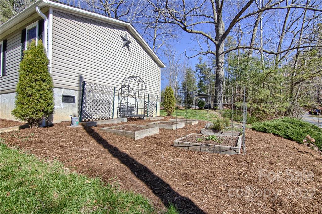 20 Cascade Village Road, Unit 2 Pisgah Forest, NC 28768 - Photo 34 of 36 a backyard of a house with outdoor seating