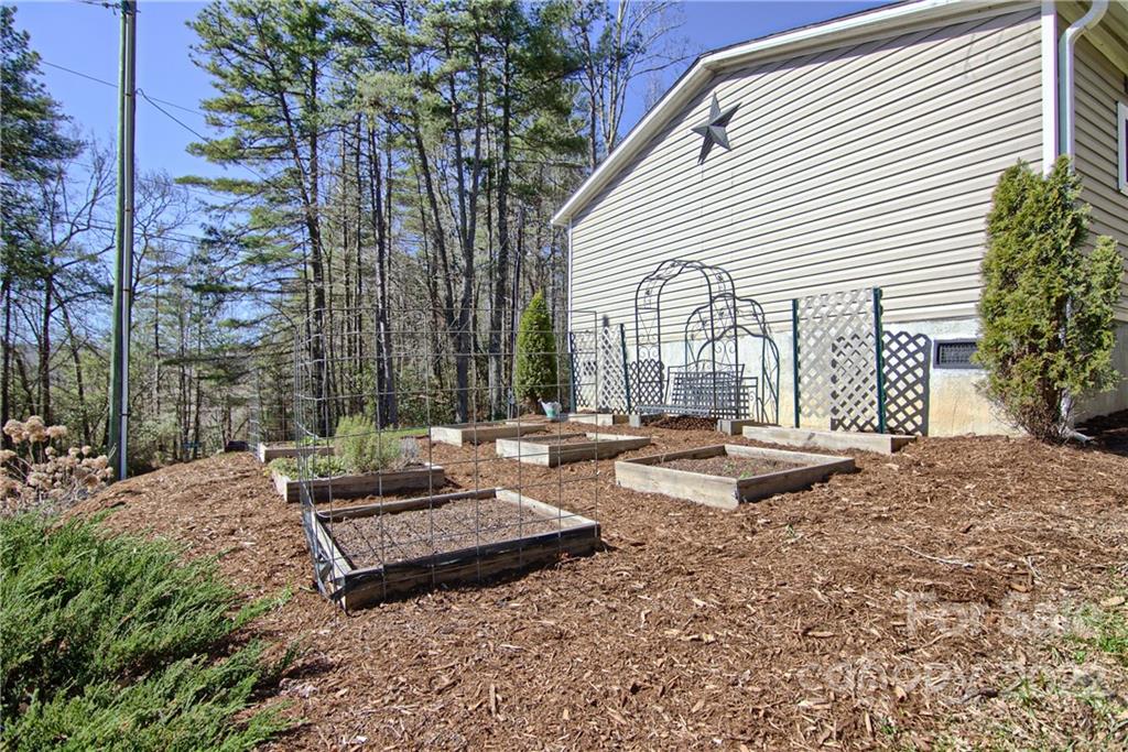 20 Cascade Village Road, Unit 2 Pisgah Forest, NC 28768 - Photo 35 of 36 a view of a backyard with chairs