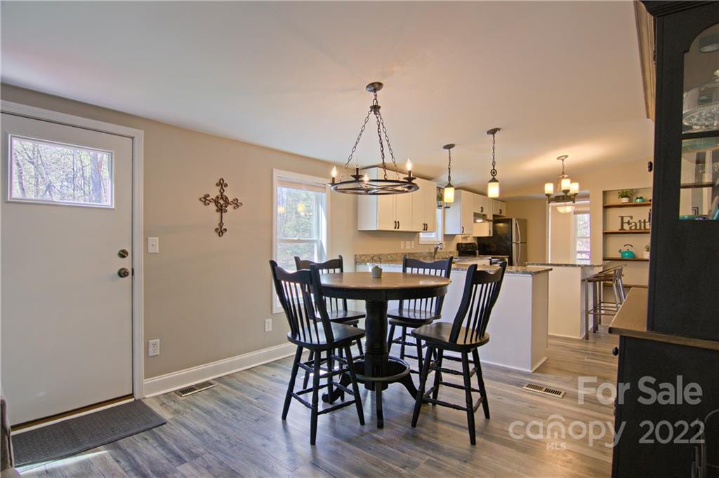 20 Cascade Village Road, Unit 2 Pisgah Forest, NC 28768 - Photo 5 of 36 a view of a dining room with furniture window and wooden floor