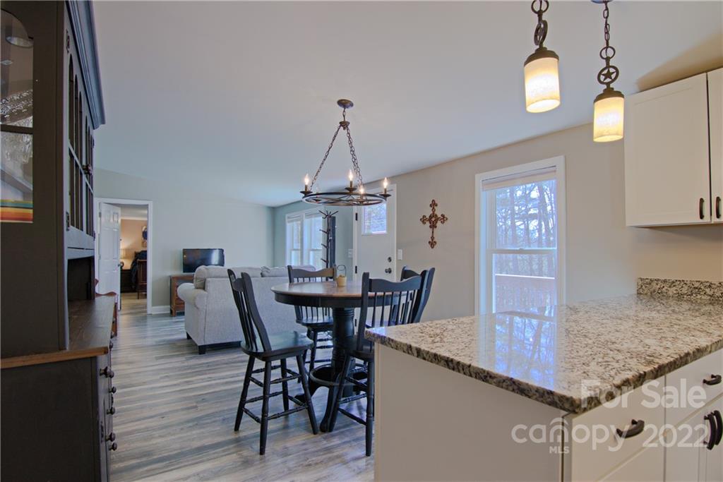 20 Cascade Village Road, Unit 2 Pisgah Forest, NC 28768 - Photo 10 of 36 a view of a dining room with furniture and wooden floor