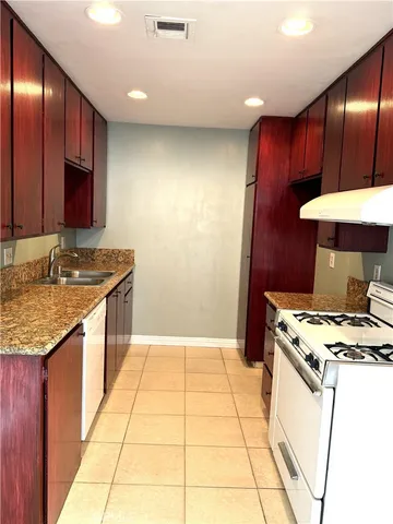a kitchen with a sink stove and cabinets