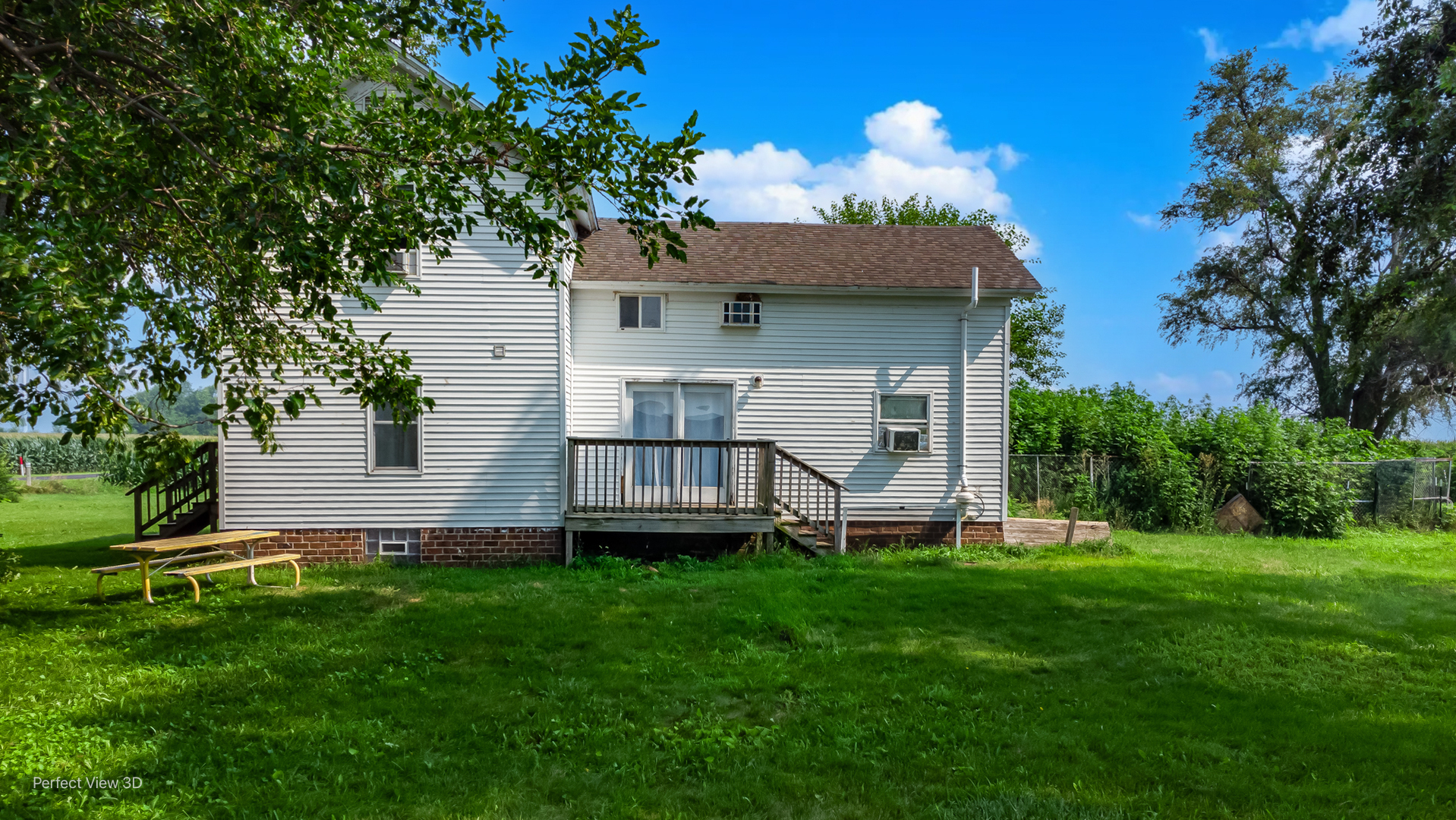 8600 South Kinsman Road Kinsman, IL 60437 - Photo 8 of 26 a front view of a house with a garden and trees