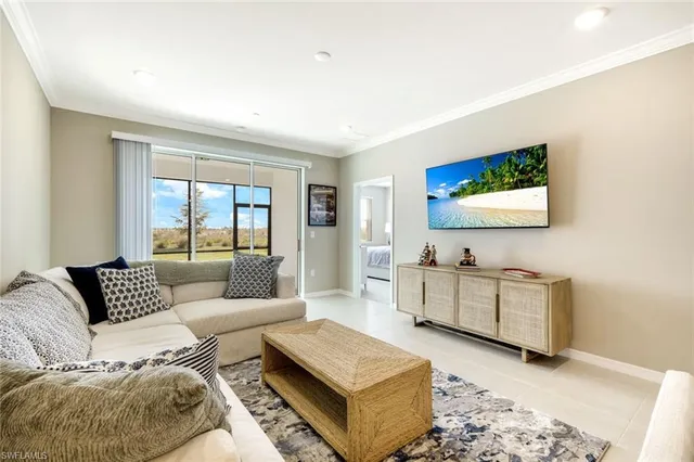 a living room with couches and a flat screen tv
