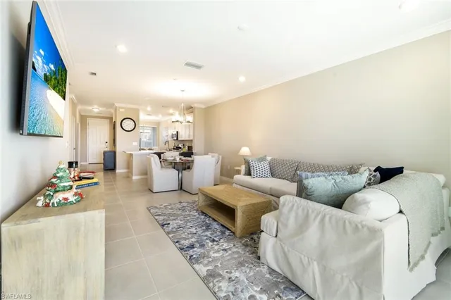 a living room with fireplace furniture and a flat screen tv