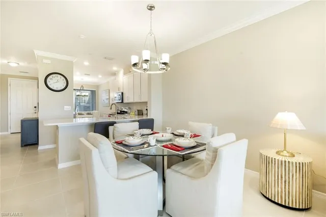 a view of kitchen with a sink a stove top oven a clock and a window