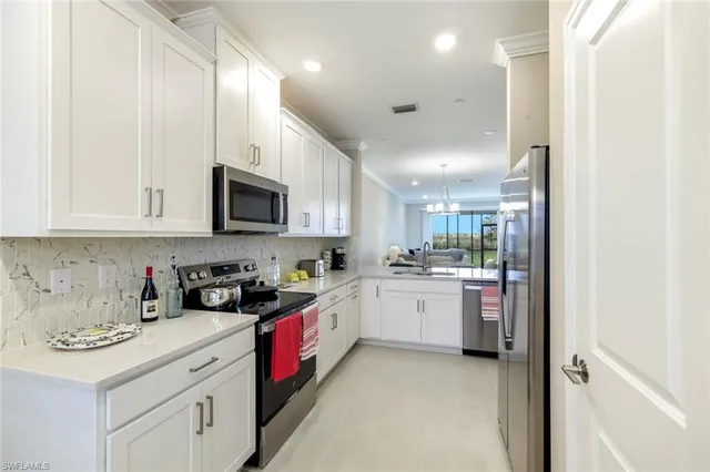 a kitchen with refrigerator and cabinets