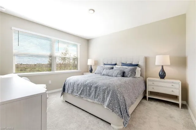 a bedroom with a large bed and a flat tv screen on dresser