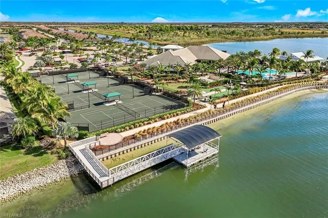an aerial view of a house with a ocean
