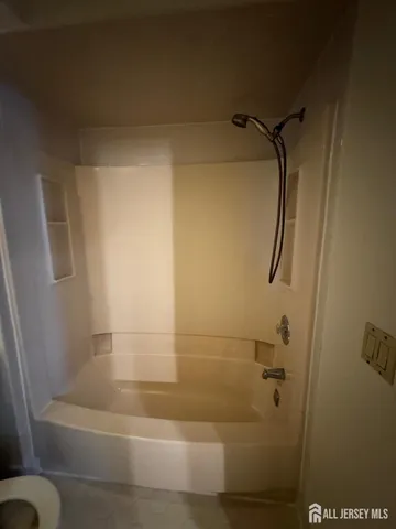 a view of a livingroom with a piano and wooden floor