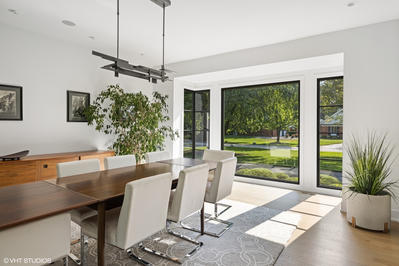 15 Longmeadow Road Winnetka, IL 60093 - Photo 13 of 71 a dining room with wooden floor a chandelier a glass table and chairs