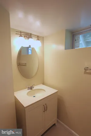 a bathroom with a sink mirror and vanity