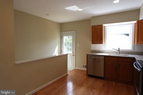 a kitchen with granite countertop a sink and a window