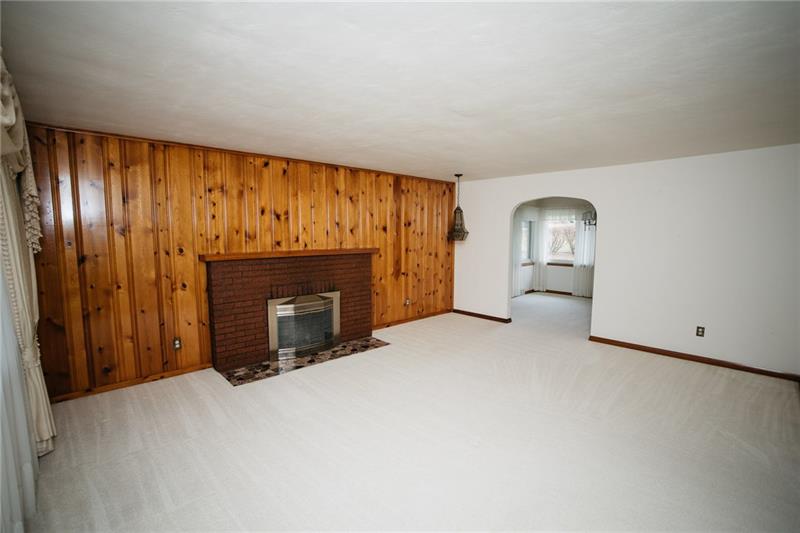 2011 Highway 130 Pleasant Unity, PA 15676 - Photo 3 of 25 19 x 15 Living room with wood burning fireplace. Dining room and sun room through arched opening.