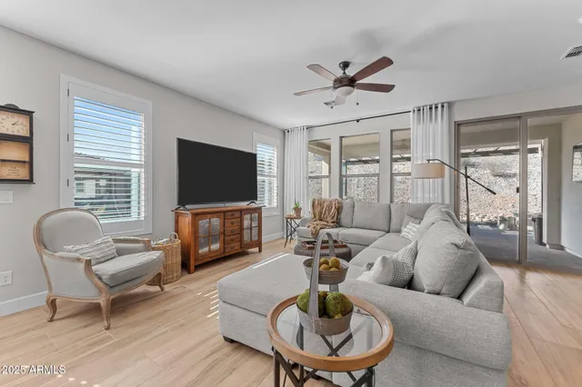 a living room with furniture a rug and a flat screen tv