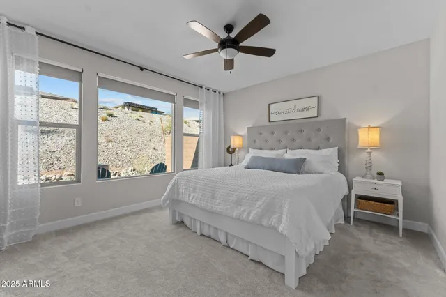 a bed room with a bed and a large window