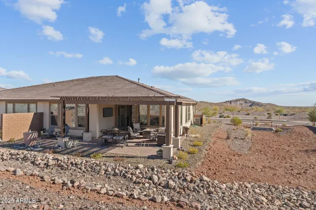 a view of a house with backyard porch and sitting area