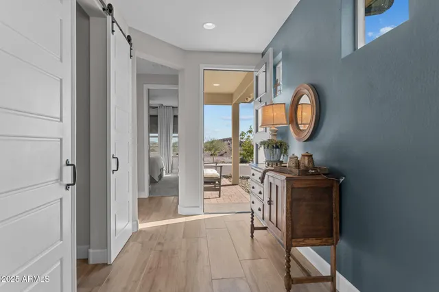 a living room with furniture a mirror and white walls