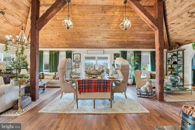 a view of a dining room with furniture a chandelier and wooden floor