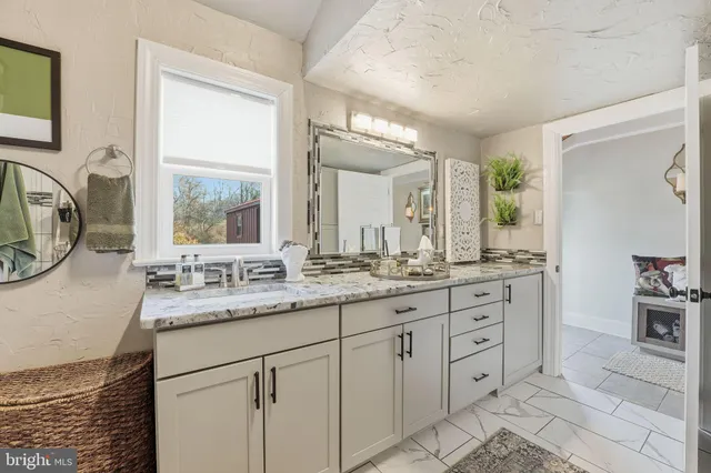a view of a house with wooden deck and furniture