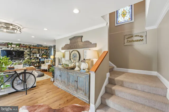 a view of a patio with couches and a table and chairs under an umbrella