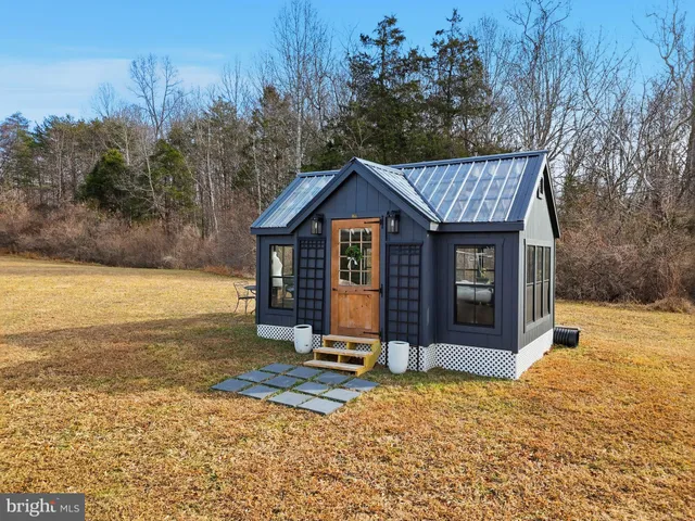 a view of a house with backyard porch and sitting area