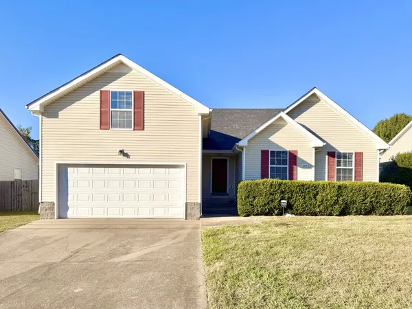 a view of a house with a yard and garage