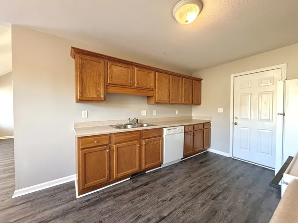 a kitchen with stove cabinets and wooden floor