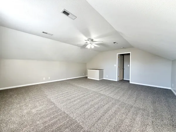 a view of a livingroom with a ceiling fan and window