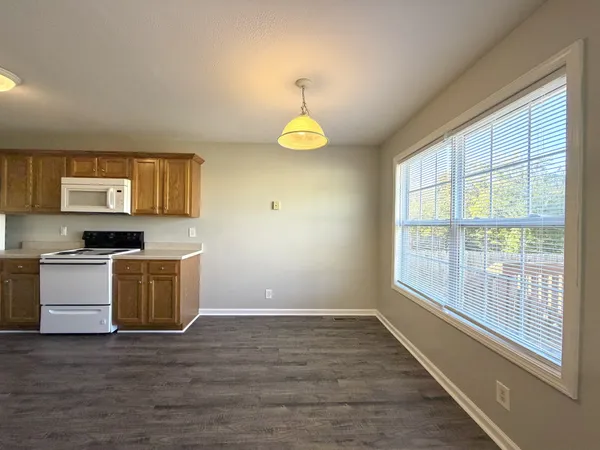 a kitchen with a refrigerator and a stove top oven