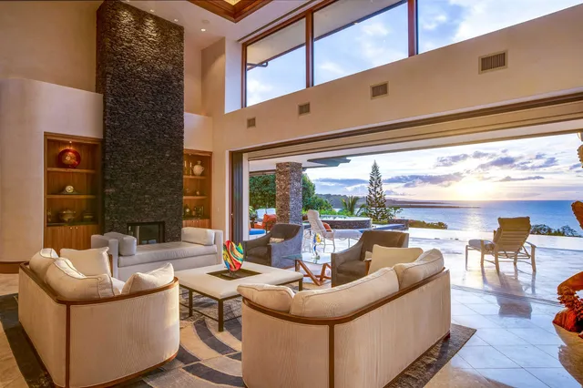 a living room with fireplace furniture and a floor to ceiling window