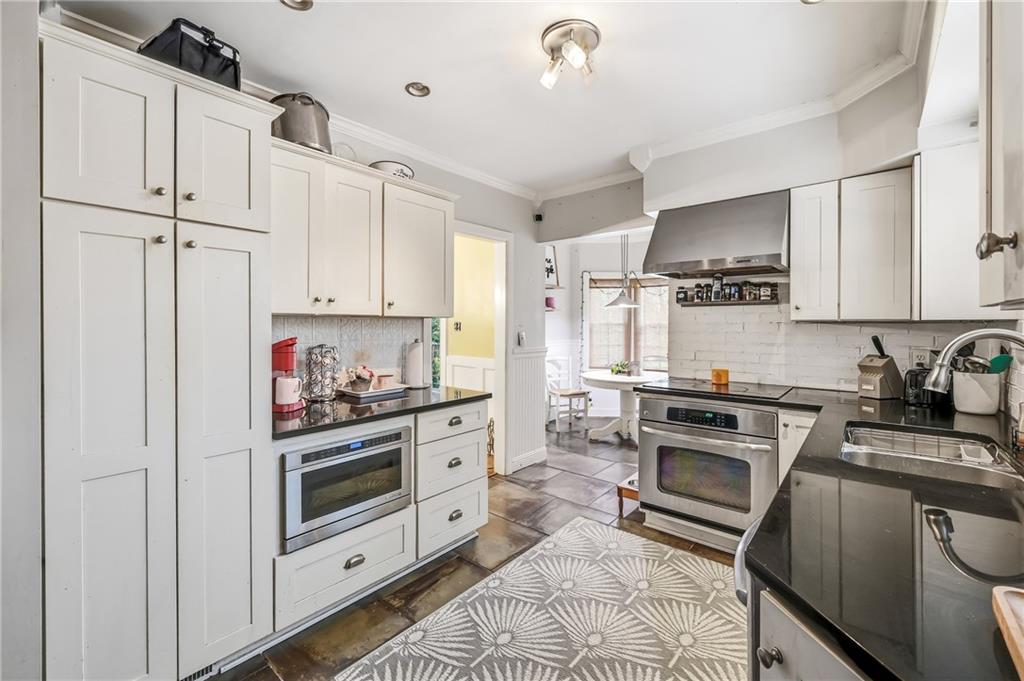371 Case Avenue Sharon, PA 16146 - Photo 11 of 41 a kitchen with granite countertop a sink stove and refrigerator