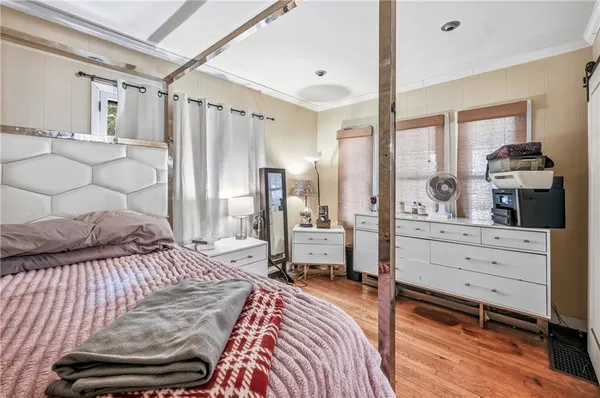 a bedroom with a bed and a dresser