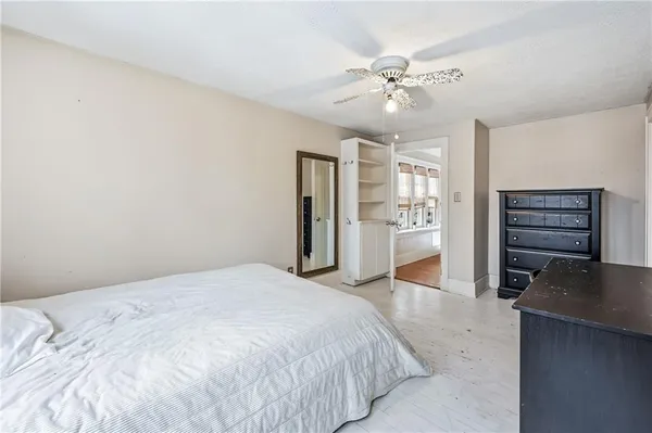 a spacious bedroom with a bed and a chandelier