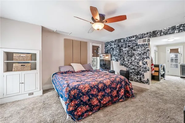 a bedroom with a bed and ceiling fan