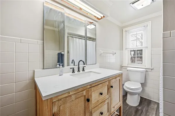 a bathroom with a sink toilet vanity and shower