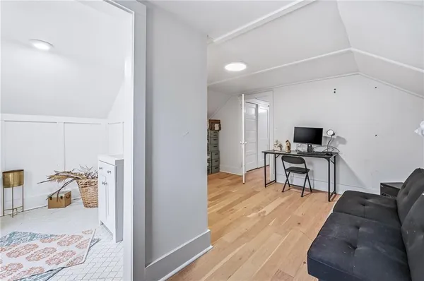 a room with wooden floor and furniture