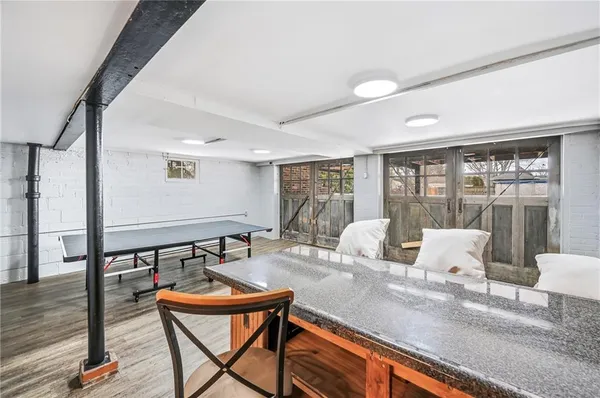 wooden floor with kitchen view and living room