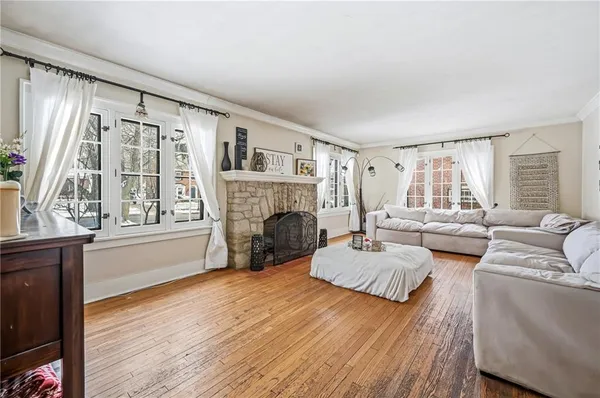 a living room with furniture fireplace and window
