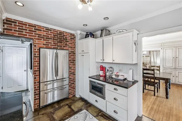 a kitchen with stainless steel appliances a refrigerator sink and cabinets