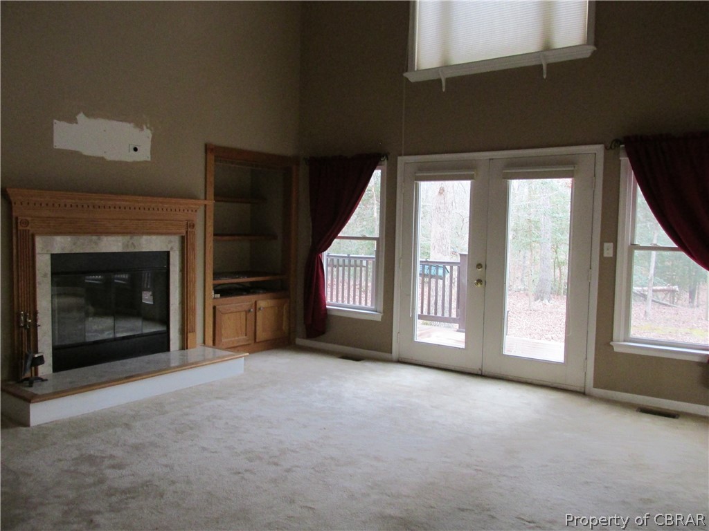 669 Croxtons Road Jamaica, VA 23079 - Photo 12 of 33 The huge 17X21 living/family room has a wood burning fireplace and built in shelving. French doors lead to the 10 X 38 slip resistant deck. Just open the doors and have a huge indoor/outdoor entertainment space.