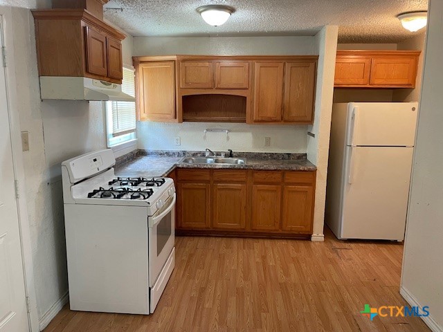 210 Carter Street Killeen, TX 76541 - Photo 6 of 11 a kitchen with a sink a stove and a refrigerator