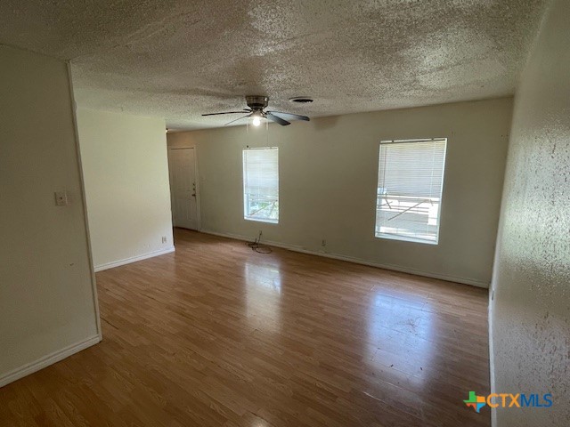 210 Carter Street Killeen, TX 76541 - Photo 7 of 11 an empty room with wooden floor and windows