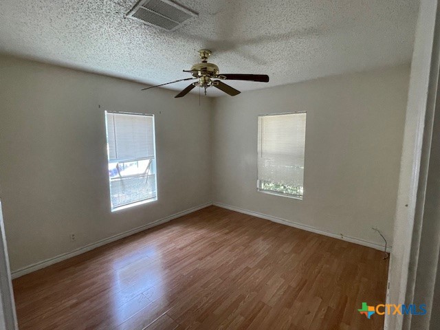 210 Carter Street Killeen, TX 76541 - Photo 8 of 11 an empty room with windows and fan