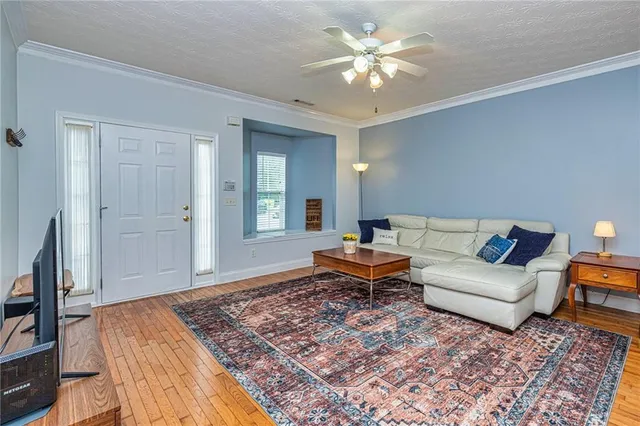 a living room with furniture and a chandelier