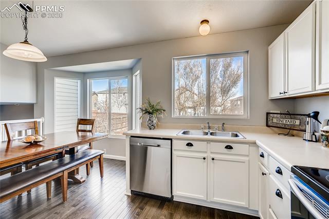 6652 Hannah Rose Road Colorado Springs, CO 80923 - Photo 9 of 28 The kitchen and eating area is perfect for casual family dinners or holiday celebrations.