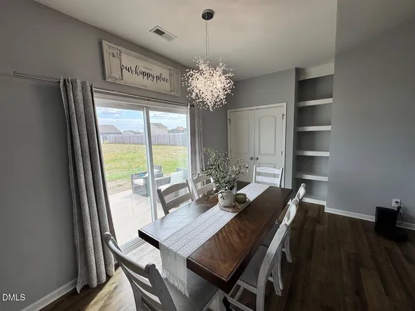 a view of a dining room with furniture wooden floor and chandelier