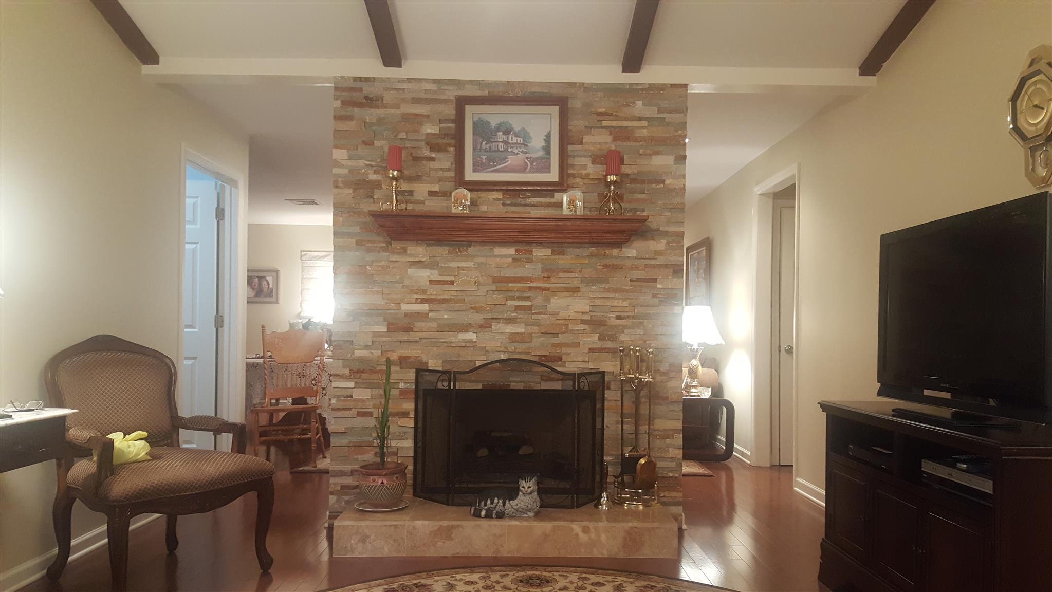 1055 General George Patton Road, Unit 1055 Nashville, TN 37221 - Photo 3 of 13 a living room with furniture and a fireplace