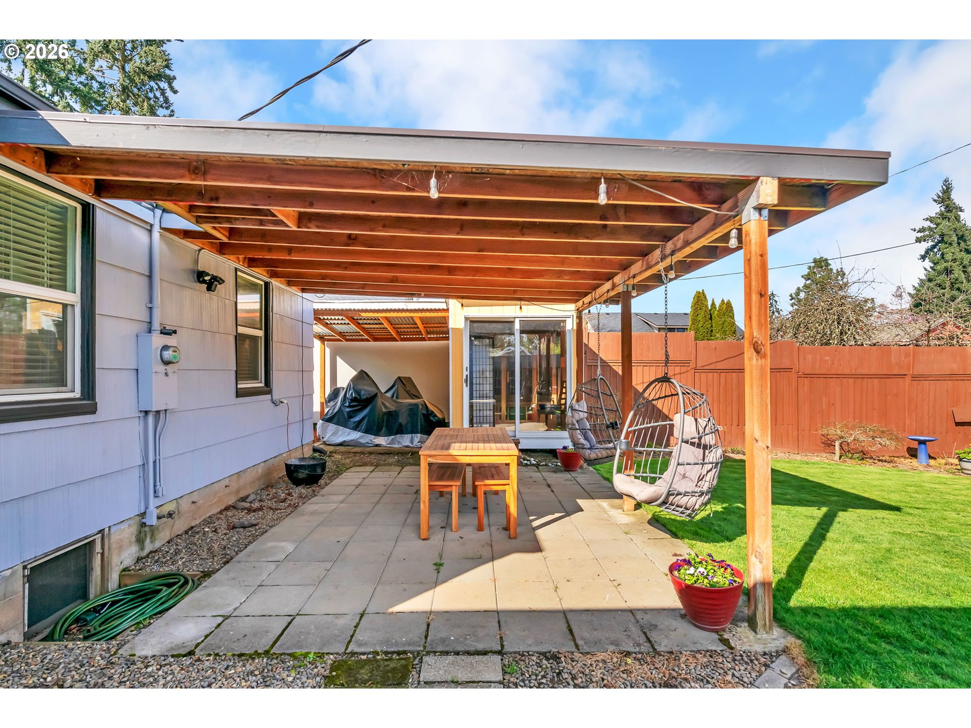 157 Hansen Lane Eugene, OR 97404 - Photo 39 of 46 a view of a patio with table and chairs under an umbrella