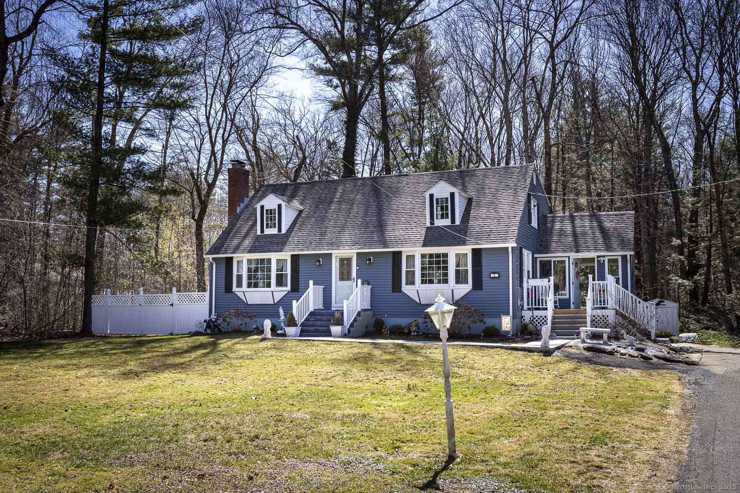 front view of house with large windows and yard